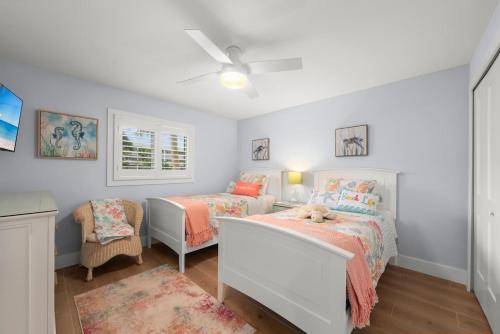 a bedroom with two beds and a dog on a bed at Island Beach Club 210E in Sanibel