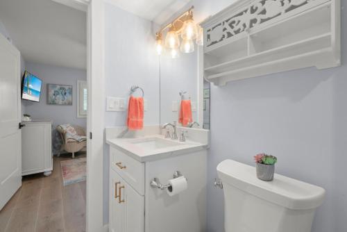 a white bathroom with a sink and a toilet at Island Beach Club 210E in Sanibel