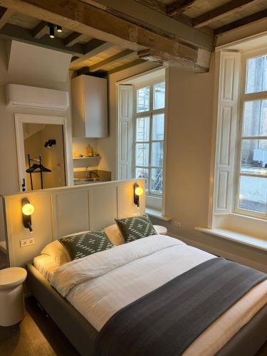 a bedroom with a large bed with two pillows at Boutique hotel the Grand in Nijmegen