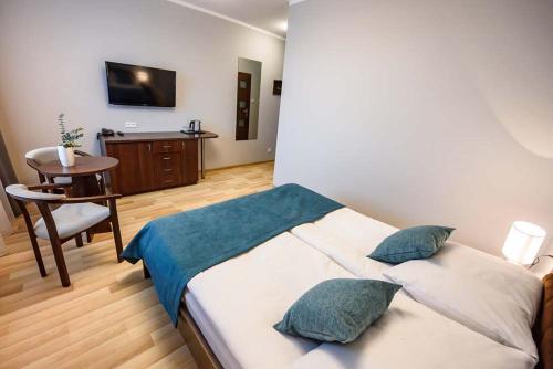 Ένα ή περισσότερα κρεβάτια σε δωμάτιο στο Ośrodek Szkoleniowo Wypoczynkowy Galicya