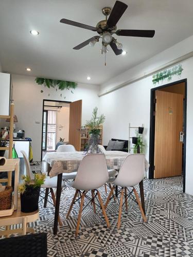 a dining room with a table and chairs at Merit Courtyard Suvarnabhumi House in Lat Krabang