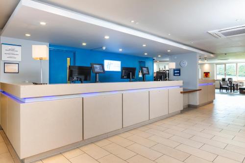 a cashier counter in a dental office with blue walls at Holiday Inn Express London - Dartford by IHG in Dartford