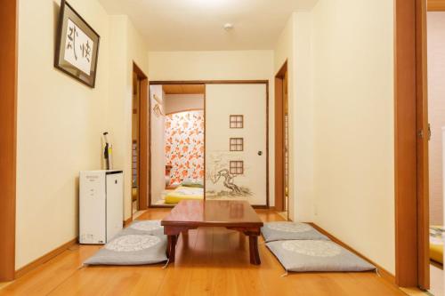 a living room with a table and a mirror at Just a short walk 心斎橋 Glico Sign 1min 道頓堀30-second 黒門市場 難波駅 Dotonbori Guesthouse 梅の阁 in Osaka