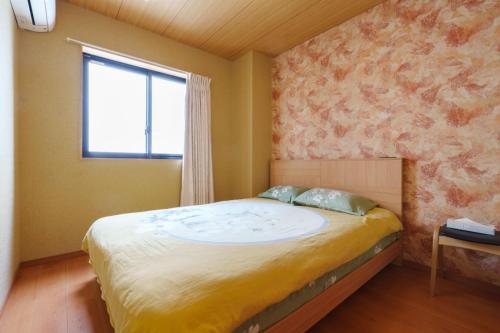 a bedroom with a large bed with a window at Just a short walk 心斎橋 Glico Sign 1min 道頓堀30-second 黒門市場 難波駅 Dotonbori Guesthouse 梅の阁 in Osaka