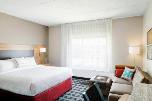 a hotel room with a bed and a couch at TownePlace Suites by Marriott Toledo Perrysburg in Perrysburg
