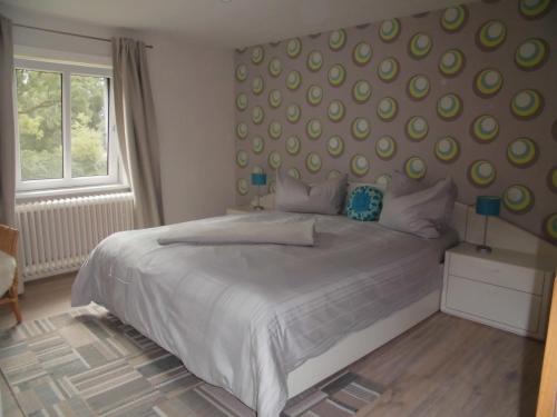 Un dormitorio con una gran cama blanca y una ventana en Apartments Schnepel, en Sankt Michaelisdonn
