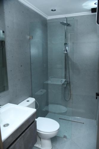 a bathroom with a shower and a toilet and a sink at Suite Bahiya 11 in Fès