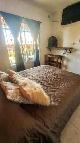 a bedroom with a large bed with a large window at PUEBLO MIO in Cosquín
