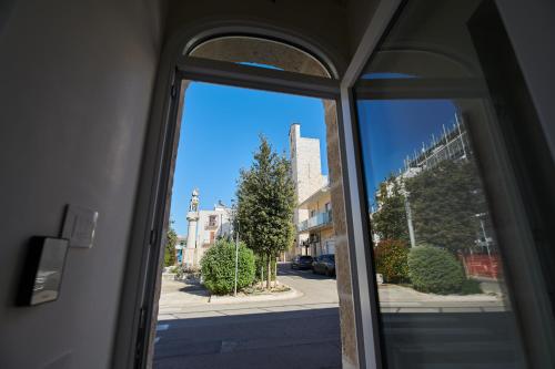 an open window with a view of a street at Domus Villanova in Triggianello