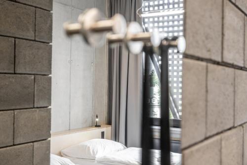 a bedroom with a bed and a window at Hotel Aréna in Jihlava