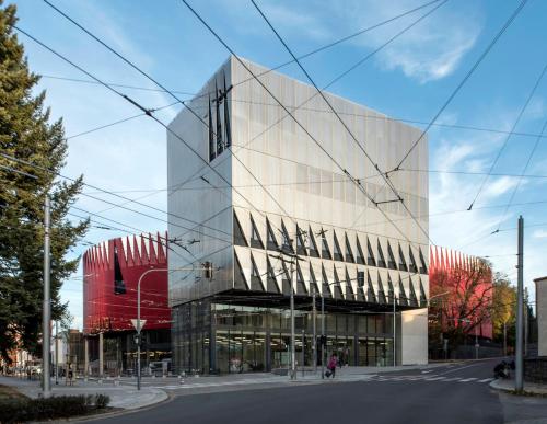 a glass building on the side of a street at Hotel Aréna in Jihlava