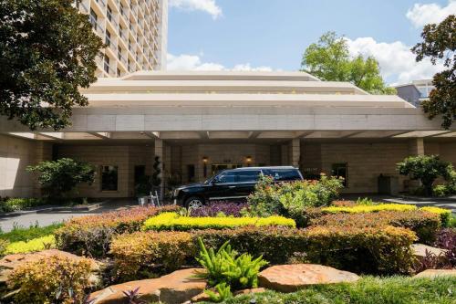 a truck parked in front of a building with flowers at The St. Regis Houston in Houston