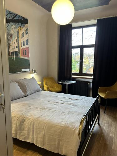 a bedroom with a bed and a large window at RedDoor Apartment 21 FreeParking in Riga