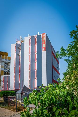 a large building with a sign on the side of it at Art Hotel Simona in Sofia