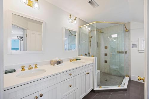 a white bathroom with a sink and a shower at DS1113: 1113 Duneside Drive in Kiawah Island