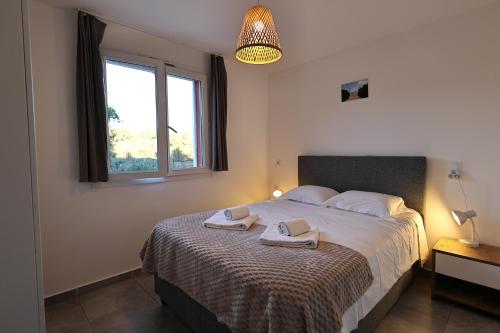 Ένα ή περισσότερα κρεβάτια σε δωμάτιο στο U Bellu - Modernité et calme à deux pas de la mer