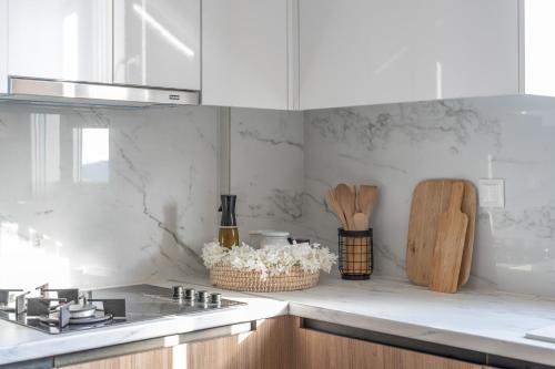 a kitchen with white marble walls and a counter top at Athena Home South Crete in Kapparianá