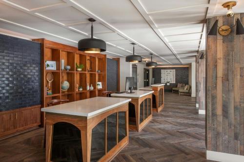 a kitchen with wooden cabinets and a counter top at FOUND Hotels, Santa Monica, Series by Marriott in Los Angeles