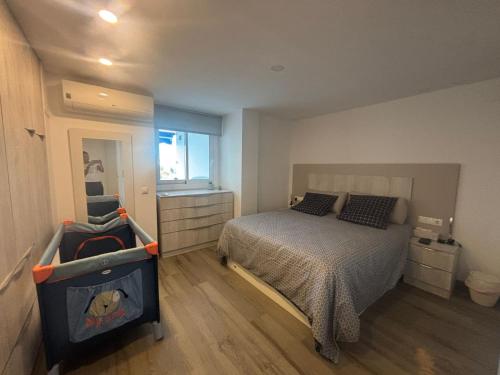 a small bedroom with a bed and a window at The luxury suite in Alicante