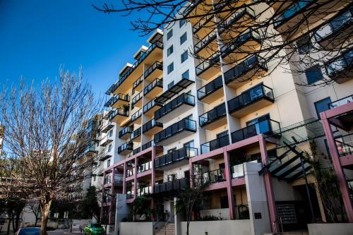an apartment building with balconies on a street at Perth Short Stays in Perth
