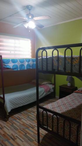a bedroom with two bunk beds and a ceiling fan at Hospedaje con Pensión Completa in Angol