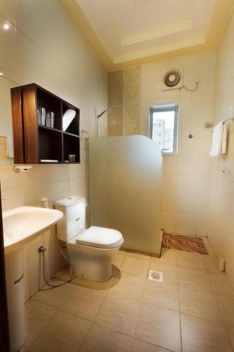 a bathroom with a toilet and a sink at Hotel Gardenz View 1 in Taif
