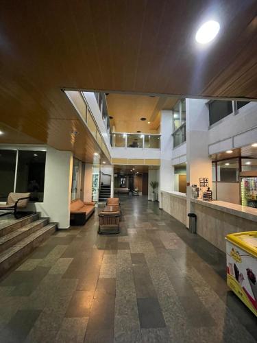 an empty lobby of a building with couches and tables at Prestige Manaus Hotel in Manaus