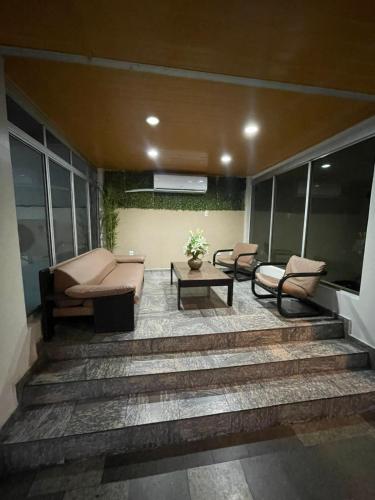 a porch with two chairs and a couch and a table at Prestige Manaus Hotel in Manaus
