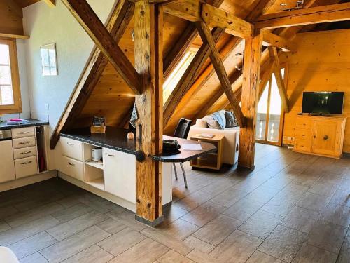 a kitchen and living room in a wooden cabin at Haus Itten in Hondrich