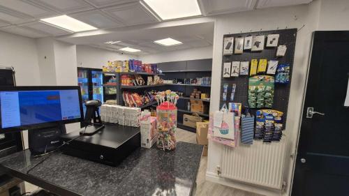 a room with a store with a desk and a computer at MARS Hotel Seaview Blackpool in Blackpool