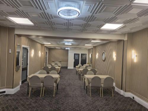 a room with rows of tables and chairs in it at MARS Hotel Seaview Blackpool in Blackpool