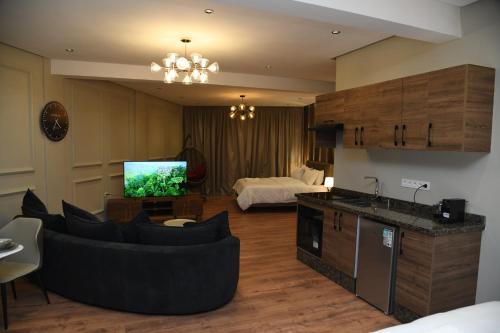 a living room with a couch and a television at Suite Bahiya 15 in Fès