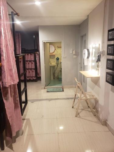 a room with a hallway with a door to a room with a dog at Lucky Guest House in Phi Phi Islands