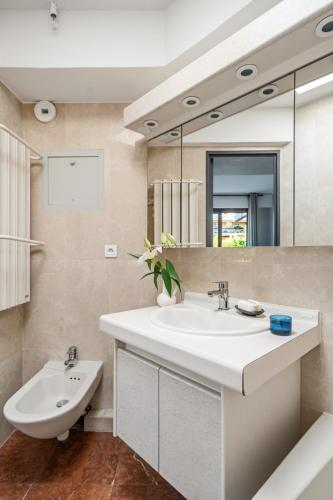 a bathroom with a sink and a mirror at Vivre Cannes l Parking l Balcony l 15min to La Croisette in Cannes
