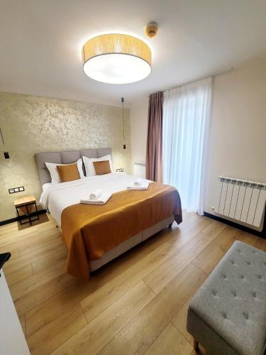 a bedroom with a large bed and a large window at Pensiunea Anton Pann in Sibiu