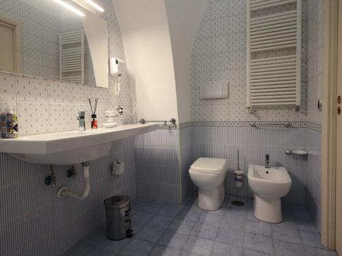 a bathroom with a sink and a toilet at Residence Stella in Pomigliano dʼArco