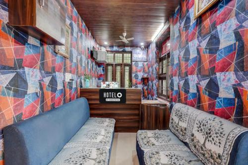 a room with a wall covered in colorful tiles at Hotel O Jagatpura Central Railway Station Jaipur in Jaipur