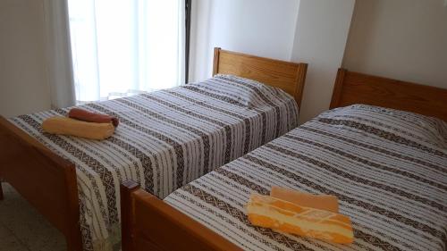 two beds sitting next to each other in a bedroom at Chariandry Court in Pissouri