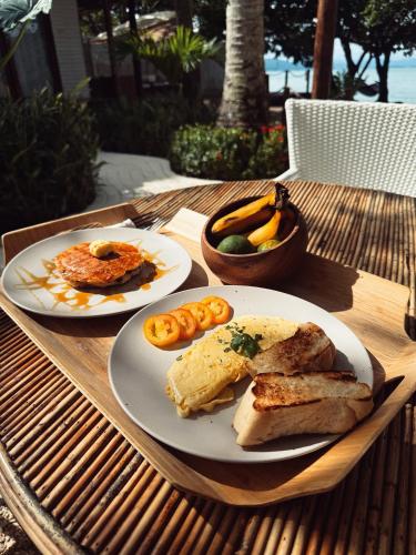 two plates of breakfast food on a table at BAIA - Beachfront Boutique Lodge in San Vicente, Palawan in San Vicente