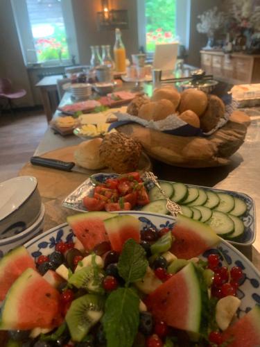 een tafel met borden groenten en fruit bij Familienpension Obere Juchhe, Ferienwohnung und Zimmer 1-12 Personen in Gräfenthal