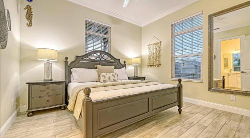 a bedroom with a large bed and two windows at Casa Antilles - 1036L in Siesta Key