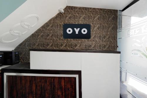 a sign on a wall above a fireplace at Hotel O Shree Guru Kanha Vaishno Dham in Chhatikara