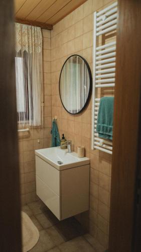 a bathroom with a sink and a mirror at Ferienwohnungen Bullau in Erbach