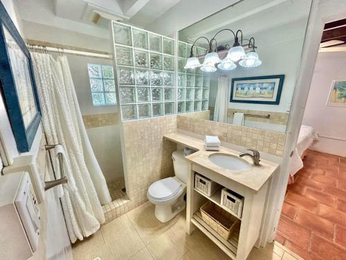 a bathroom with a sink and a toilet at Baked and Barefoot Beach Bunglows in St. George Island