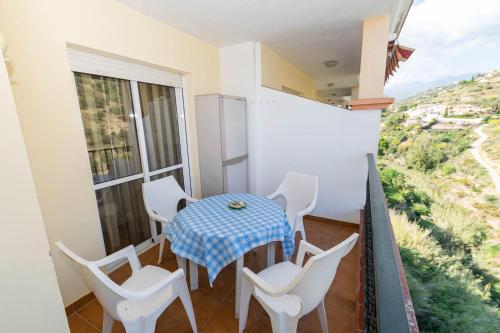 a balcony with a table and chairs and a view at Apartment Mountain View in Torrox