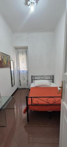 a bedroom with a bed with a red blanket at San Vincenzo B in Genoa