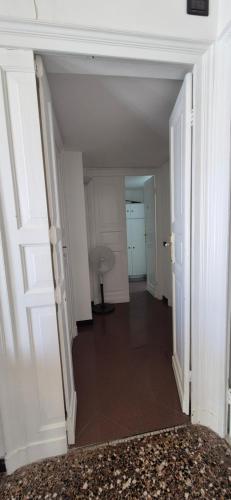 an empty hallway with white walls and white doors at San Vincenzo B in Genoa