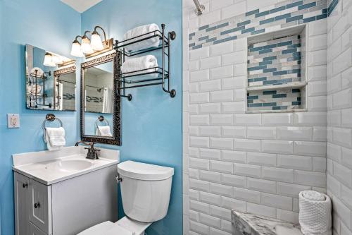 a bathroom with a toilet and a sink and a mirror at Plumbago - 5251C in Siesta Key
