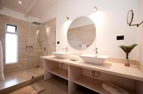 a bathroom with two sinks and a shower at Astra Hotel Boutique in Nosara