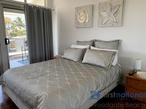 a bedroom with a bed and a starfish on the wall at 4/139 The Esplanade in Woodgate